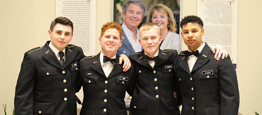 four cadets in dress uniform